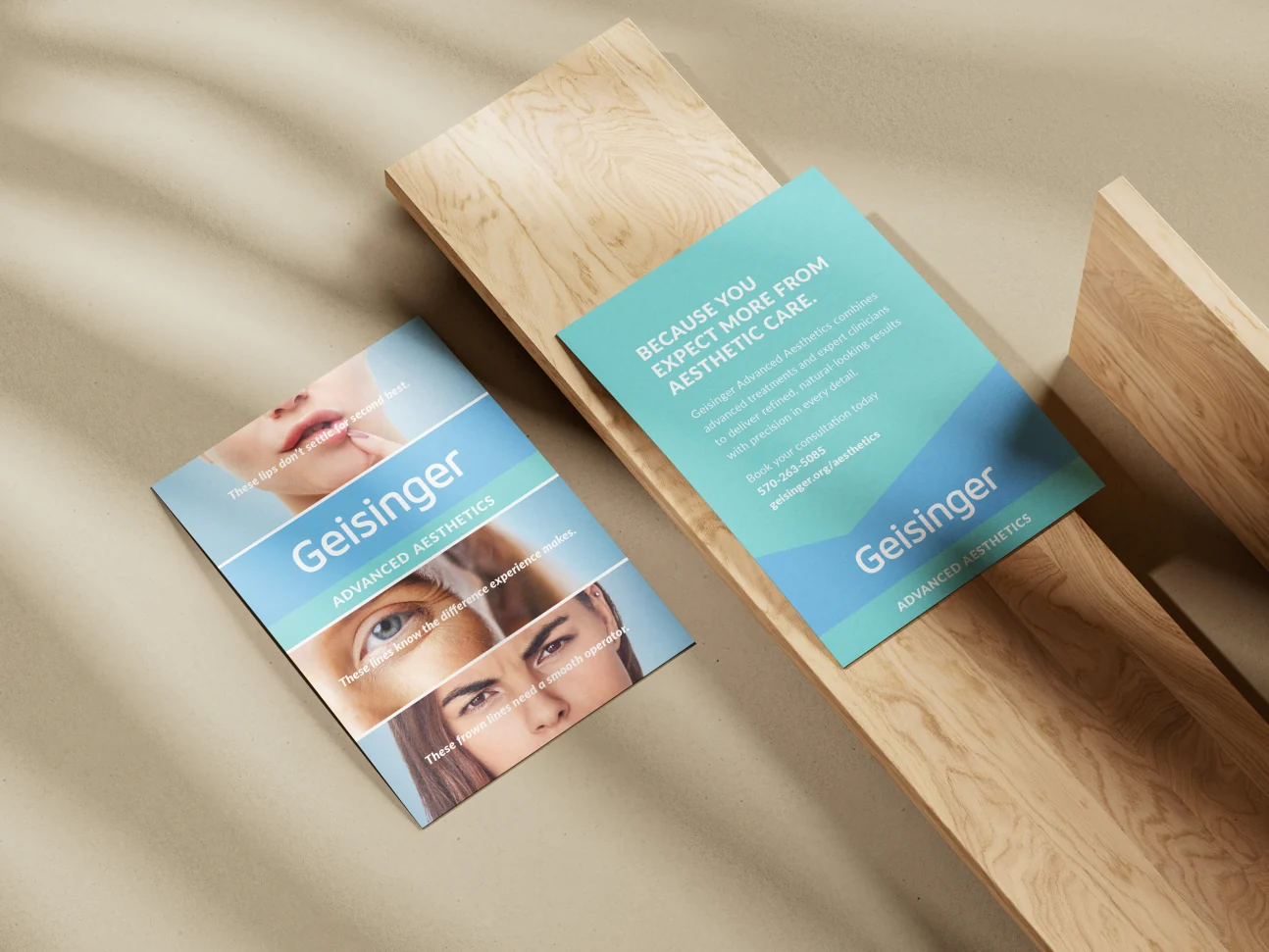 Geisinger Advanced Aesthetics promotional cards arranged on fabric
