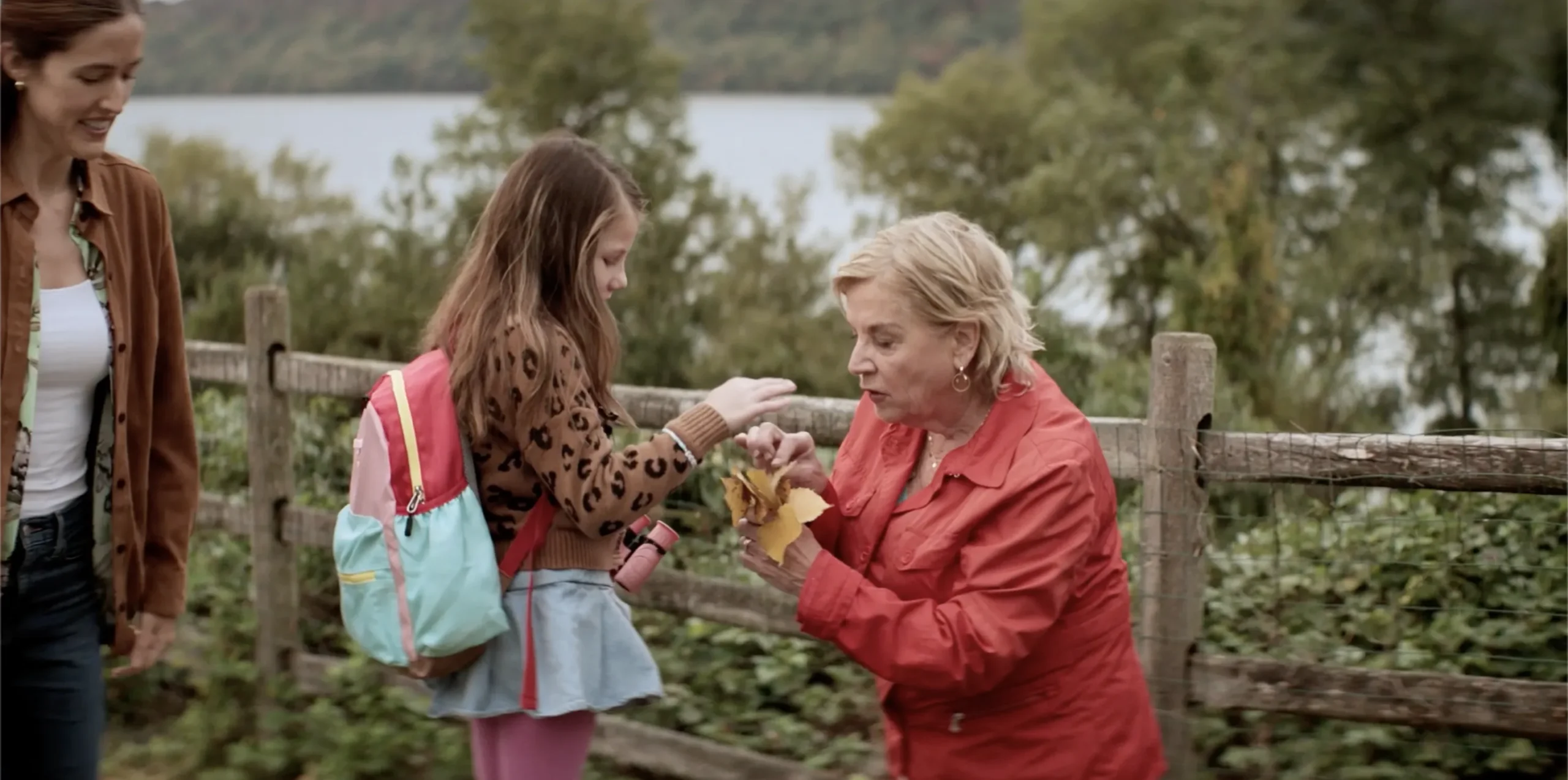 A girl meets an older woman outdoors at RiverSpring Living